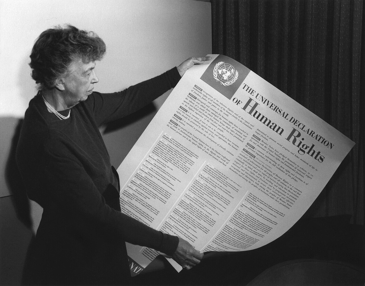 Eleanor Roosevelt with the poster of the Universal Declaration of Human Rights, 1949.